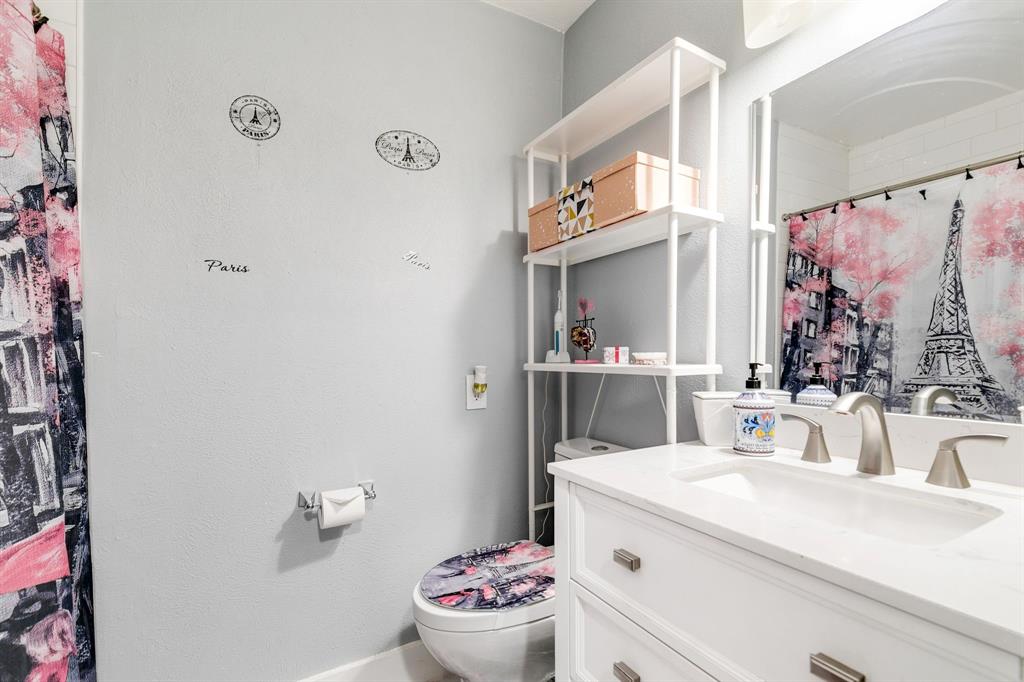 4347 Dickason Avenue, Unit 111 Dallas, TX 75219 - Photo 21 of 37 a bathroom with a sink and a mirror