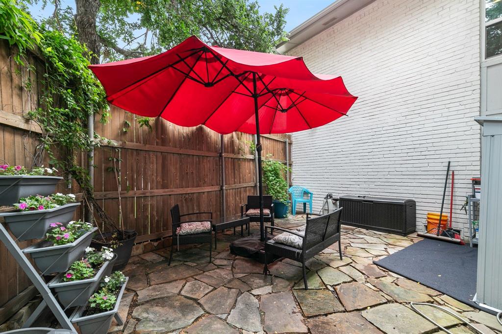 4347 Dickason Avenue, Unit 111 Dallas, TX 75219 - Photo 27 of 37 an outdoor space with furniture and umbrella