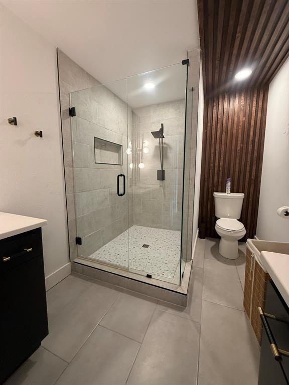 4347 Dickason Avenue, Unit 111 Dallas, TX 75219 - Photo 35 of 37 a bathroom with a shower and a toilet