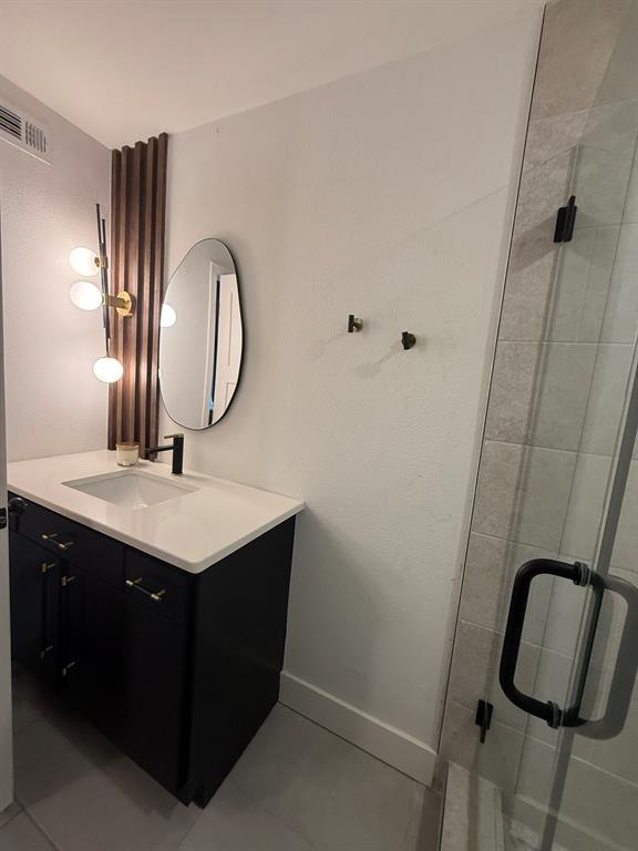 4347 Dickason Avenue, Unit 111 Dallas, TX 75219 - Photo 36 of 37 Full bath featuring vanity and a shower stall