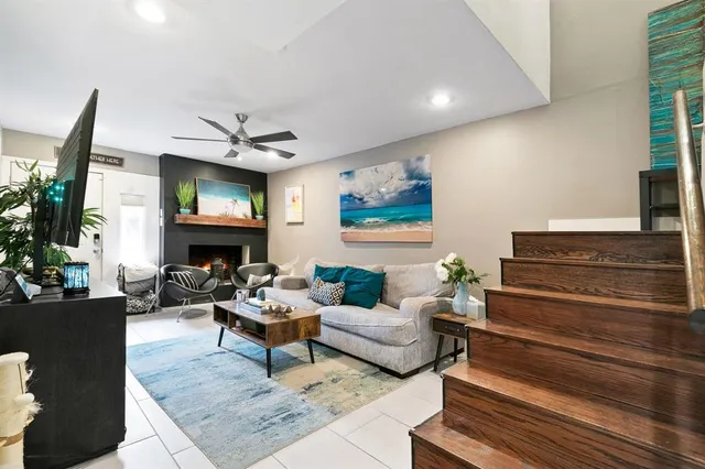 a living room with furniture and a ceiling fan