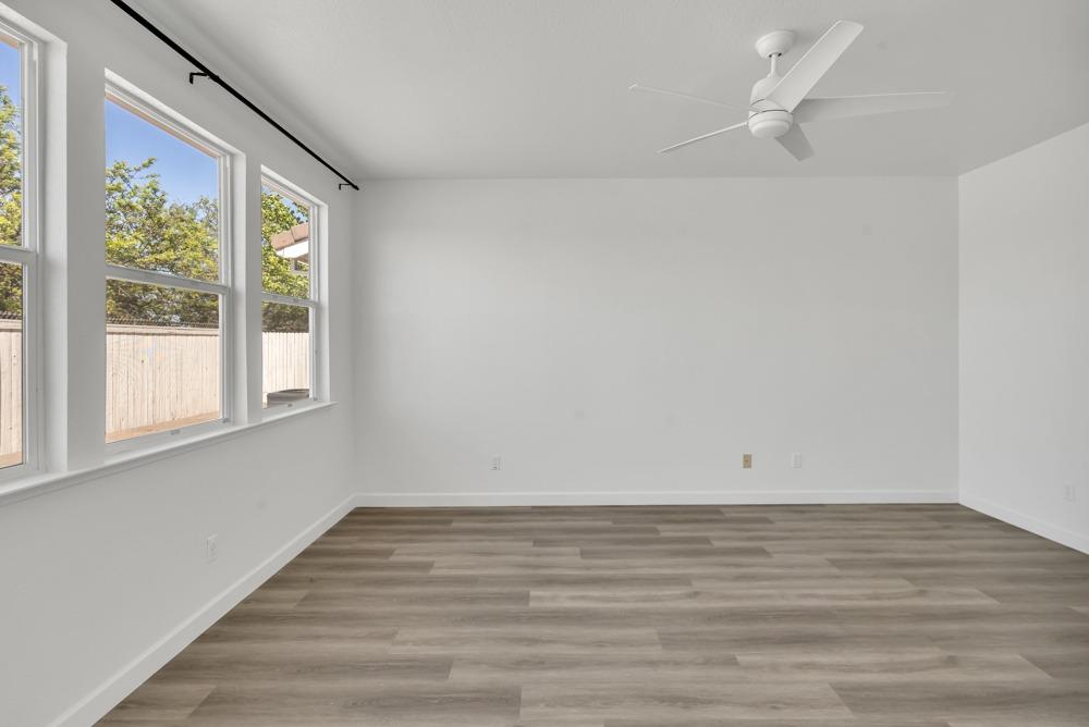 6217 Jefjen Way Elk Grove, CA 95757 - Photo 16 of 41 a view of an empty room with wooden floor and a window