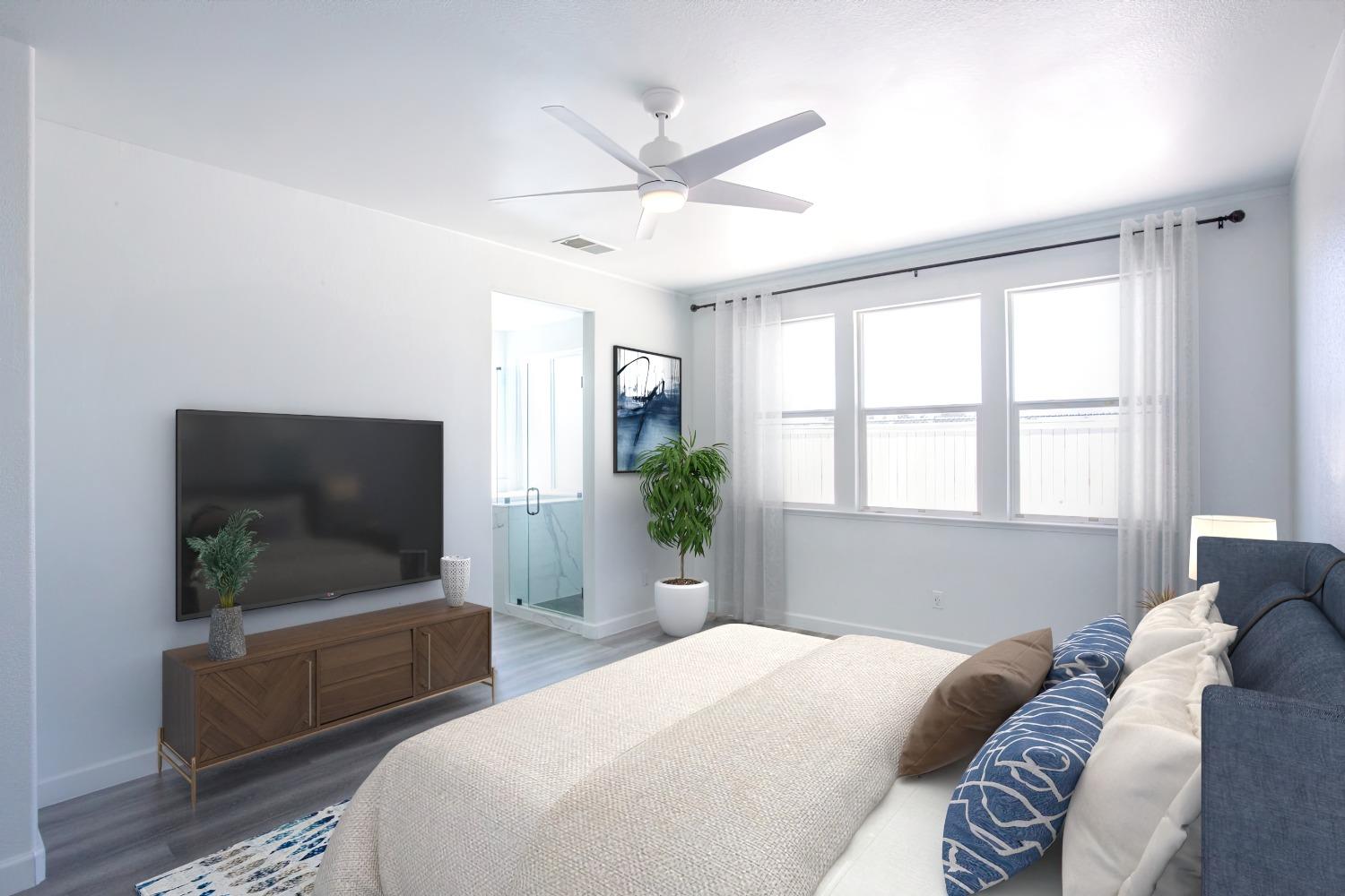 6217 Jefjen Way Elk Grove, CA 95757 - Photo 18 of 41 a bedroom with a large bed and a flat screen tv