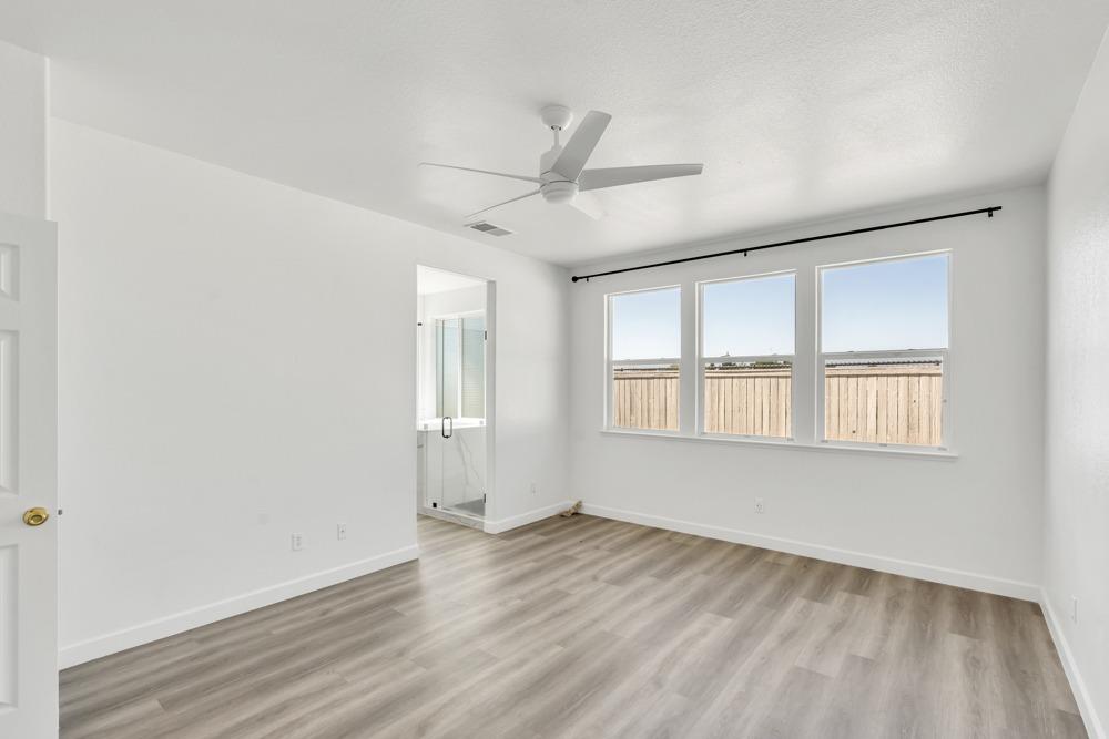 6217 Jefjen Way Elk Grove, CA 95757 - Photo 19 of 41 an empty room with wooden floor and windows