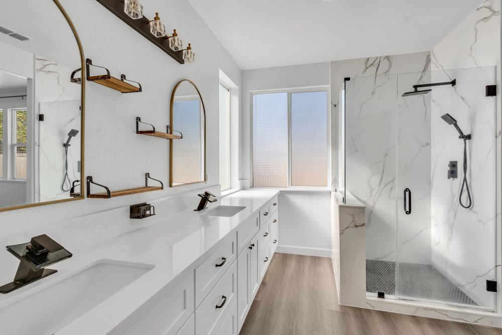 6217 Jefjen Way Elk Grove, CA 95757 - Photo 22 of 41 a spacious bathroom with a tub sink mirror and vanity