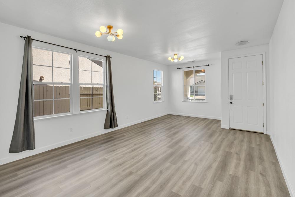 6217 Jefjen Way Elk Grove, CA 95757 - Photo 7 of 41 wooden floor in an empty room with a window
