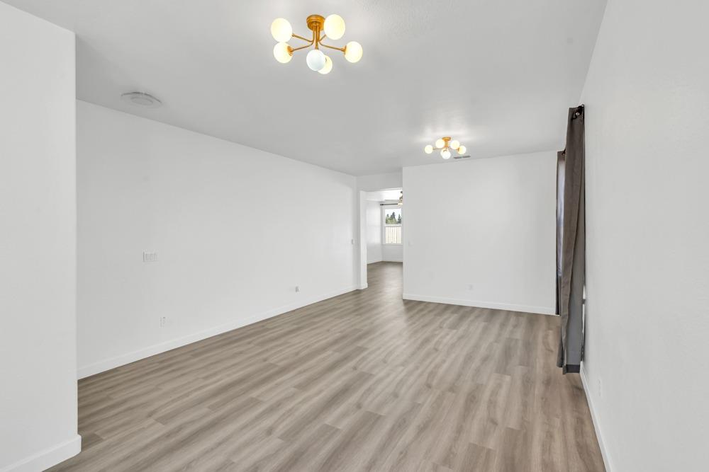 6217 Jefjen Way Elk Grove, CA 95757 - Photo 8 of 41 a view of an empty room with wooden floor