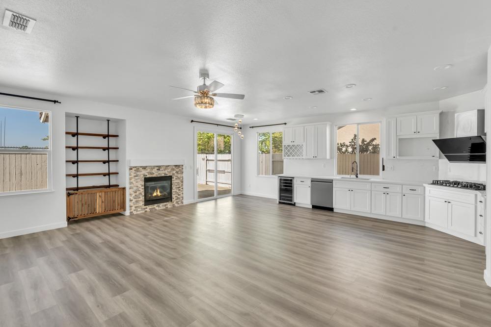 6217 Jefjen Way Elk Grove, CA 95757 - Photo 10 of 41 a view of a kitchen with furniture a ceiling fan and wooden floor