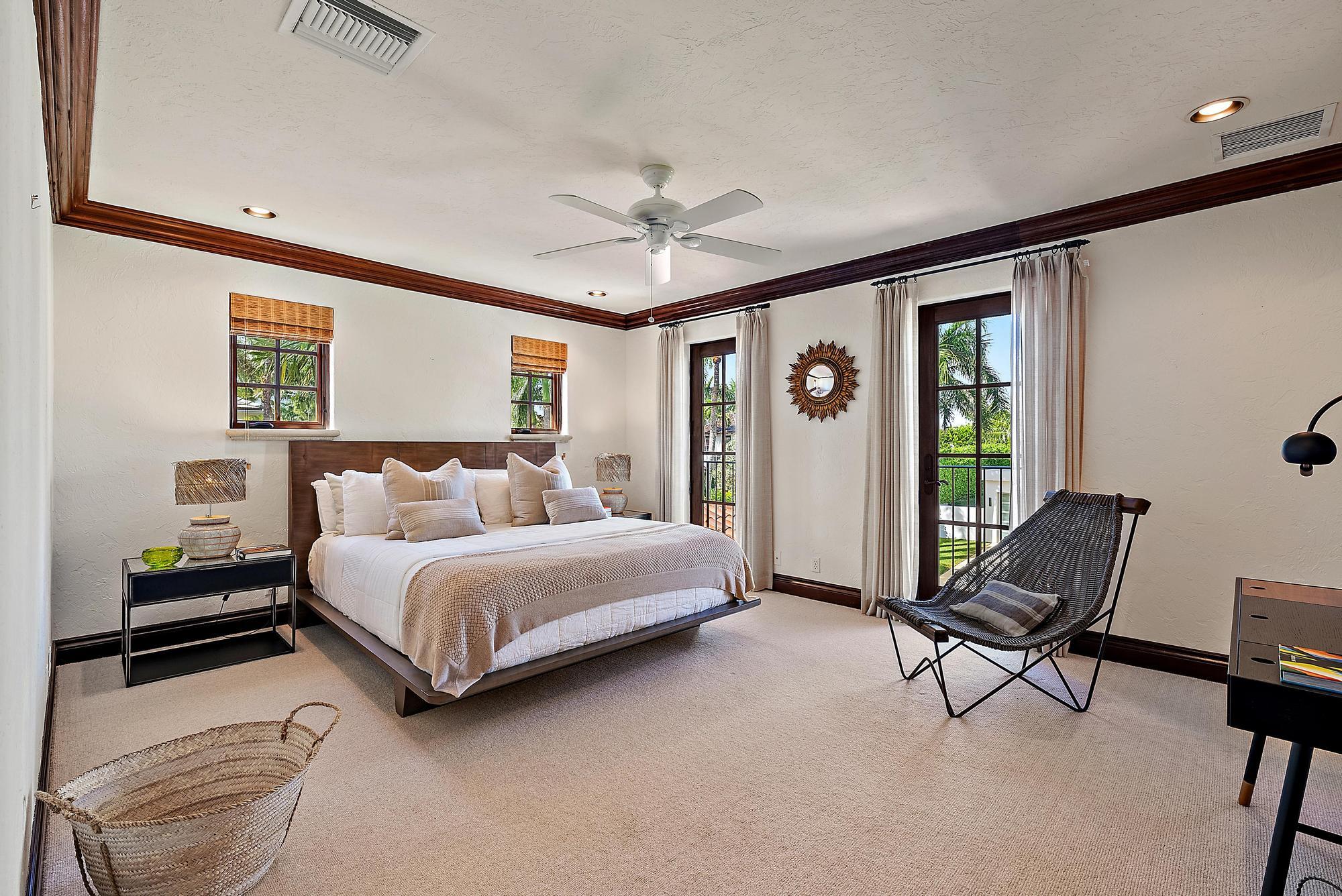 234 Ridgeview Drive Palm Beach, FL 33480 - Photo 15 of 20 a spacious bedroom with a bed and a chandelier