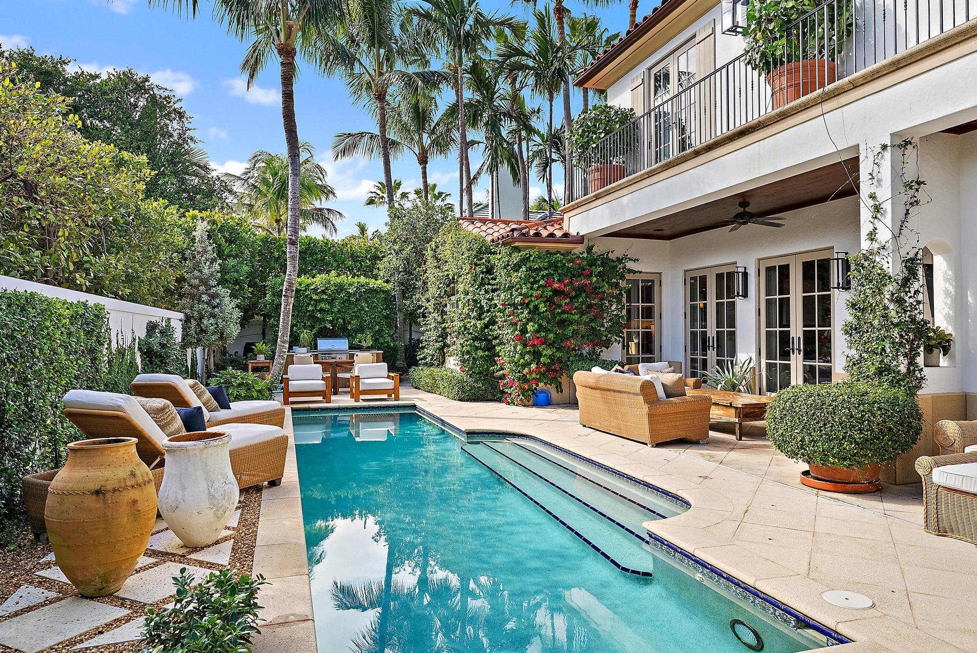 234 Ridgeview Drive Palm Beach, FL 33480 - Photo 4 of 20 a view of a patio with couches table and chairs potted plants and palm trees