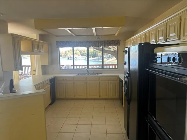a kitchen with cabinets and window