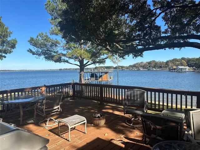 a view of a roof deck with wooden floor and fence
