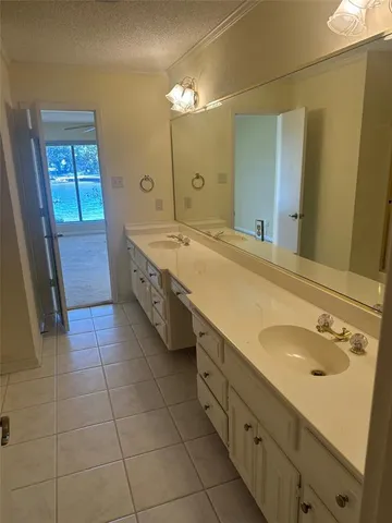 a spacious bathroom with a sink a mirror and a bathtub