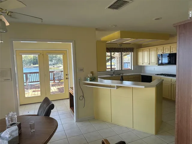 a kitchen with a sink cabinets and window