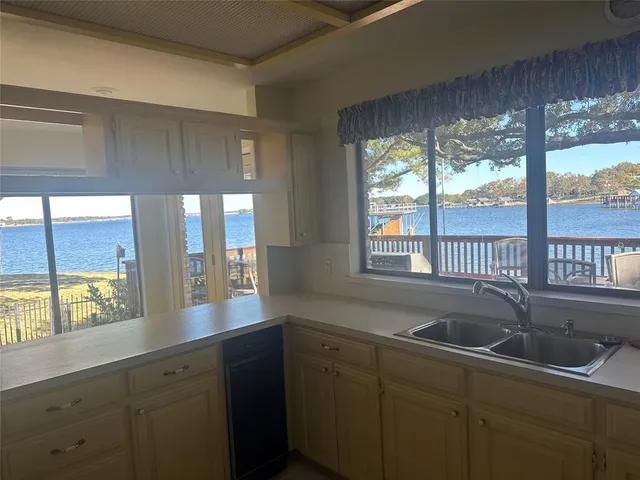a kitchen with a sink and large window