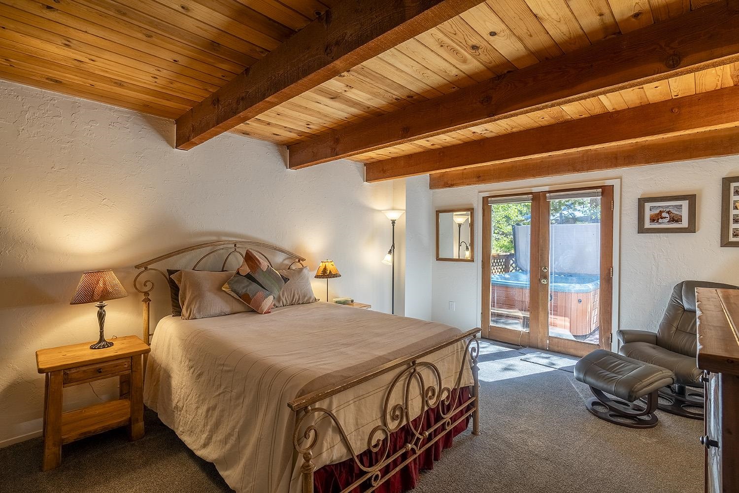 390 Forest Glen Road Olympic Valley, CA 96146 - Photo 11 of 25 a bedroom with a bed a couch and large windows