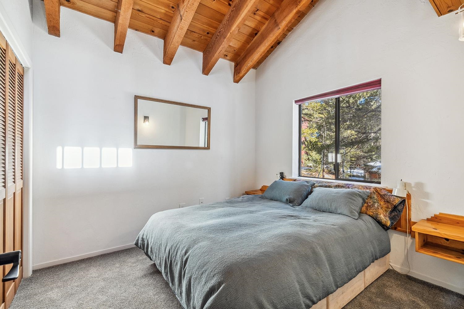 390 Forest Glen Road Olympic Valley, CA 96146 - Photo 15 of 25 a bedroom with a bed and window