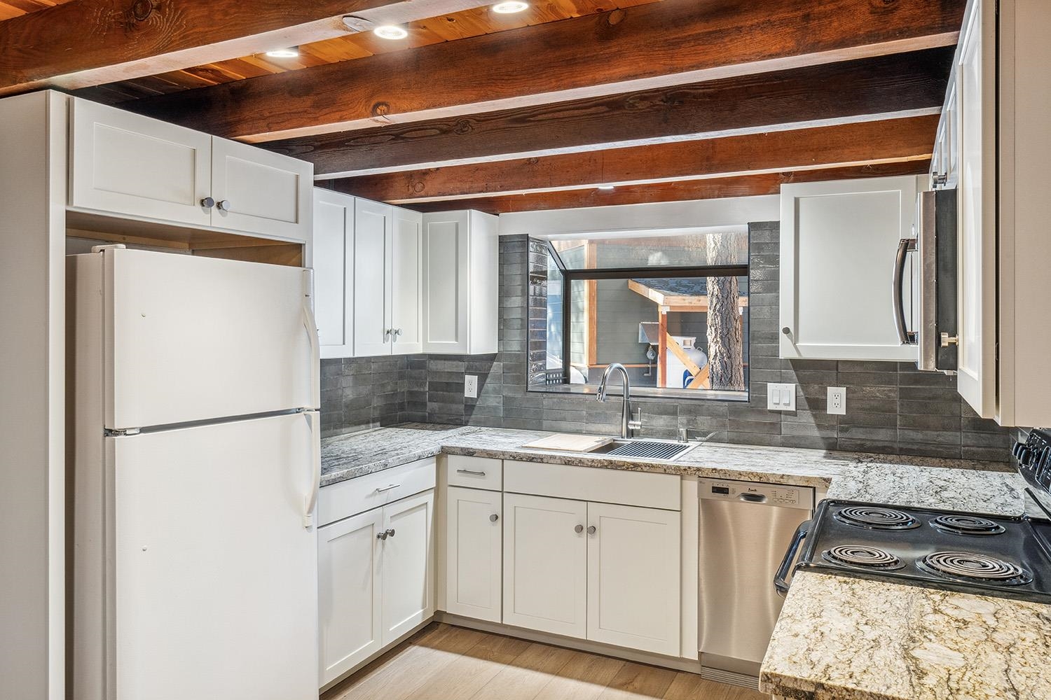 390 Forest Glen Road Olympic Valley, CA 96146 - Photo 18 of 25 a kitchen with a sink and a refrigerator