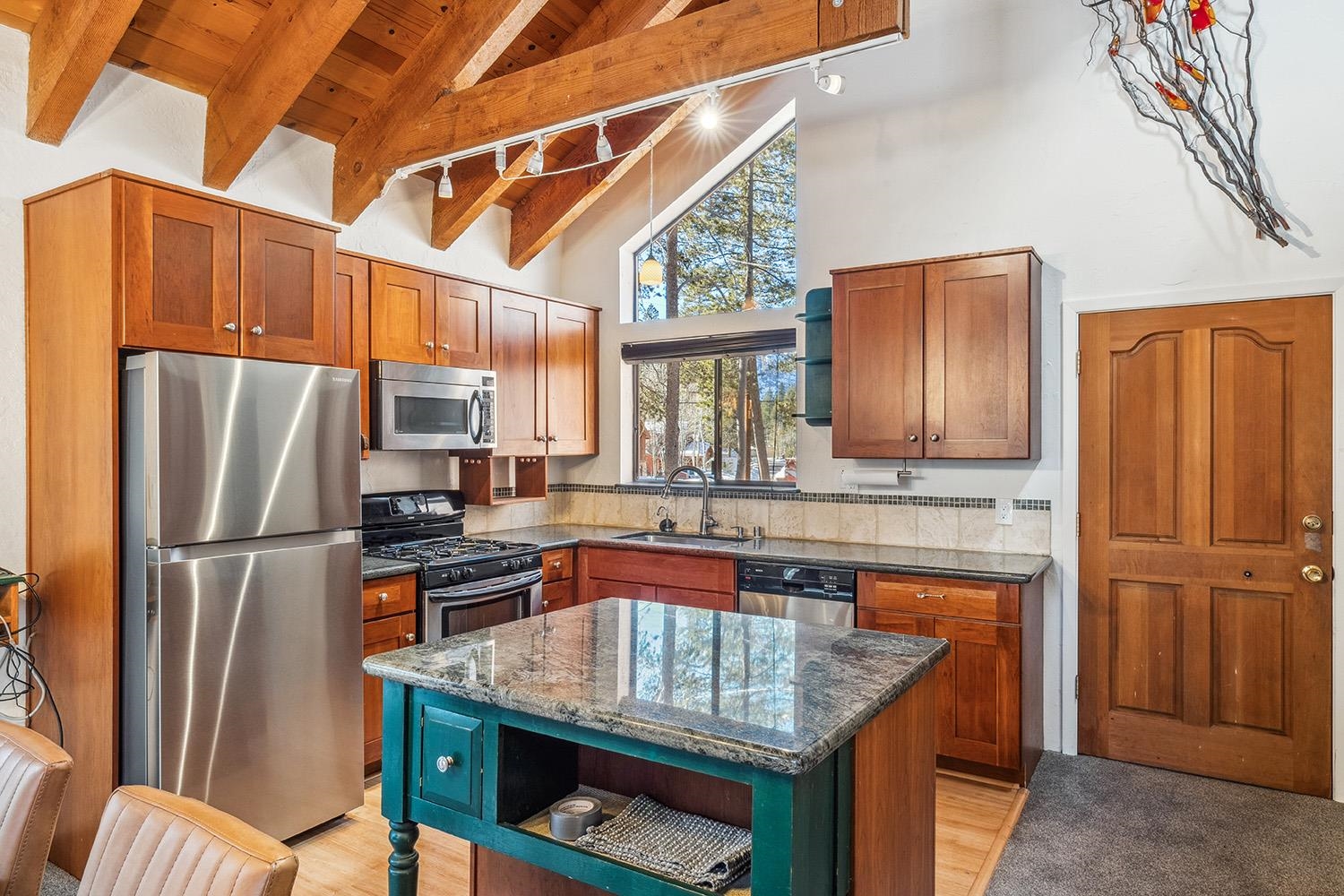 390 Forest Glen Road Olympic Valley, CA 96146 - Photo 8 of 25 a kitchen with stainless steel appliances granite countertop a refrigerator and a stove top oven