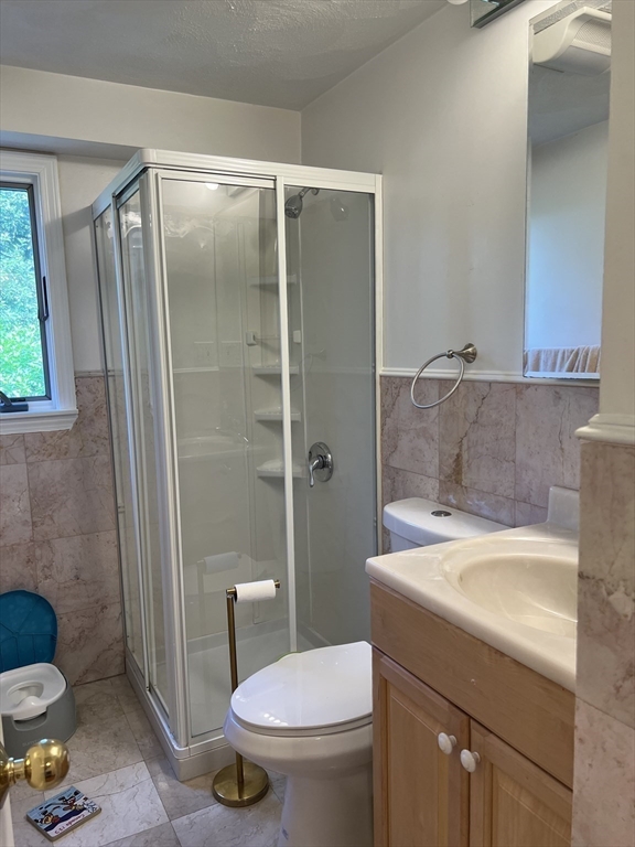 11 Garrison Road, Unit 1 Arlington, MA 02474 - Photo 30 of 42 a bathroom with a sink a toilet and shower