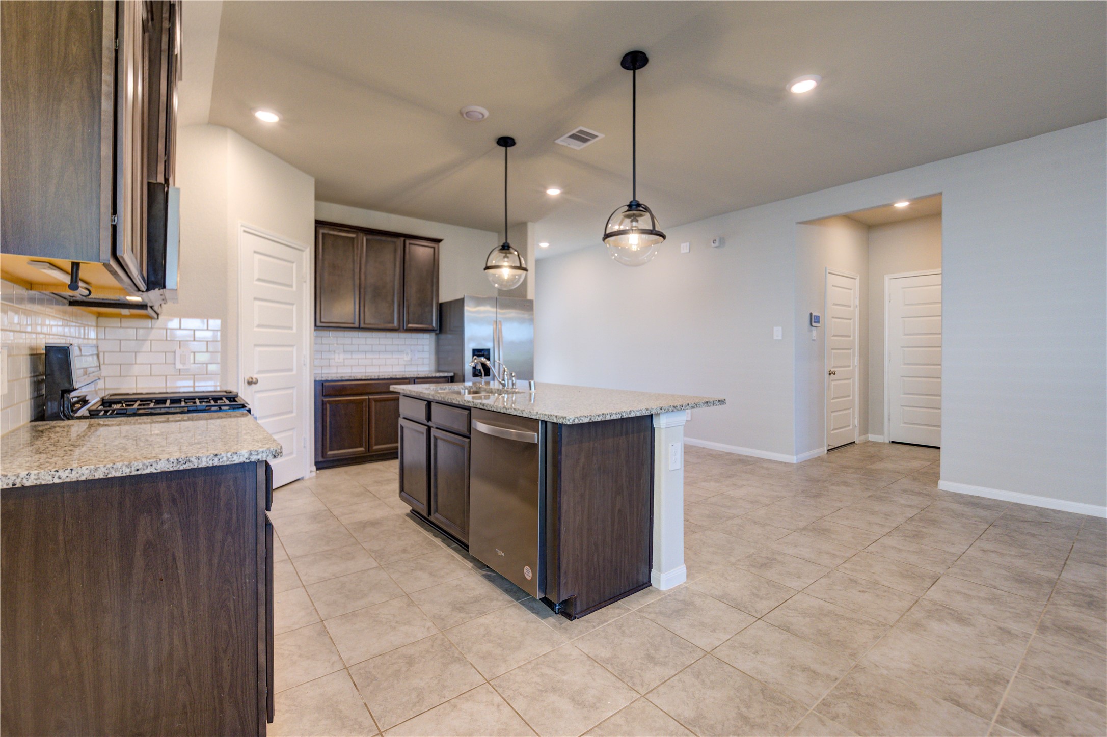 1207 Cascade Hls Drive Rosharon, TX 77583 - Photo 16 of 41 a kitchen with stainless steel appliances granite countertop a sink a stove and a refrigerator