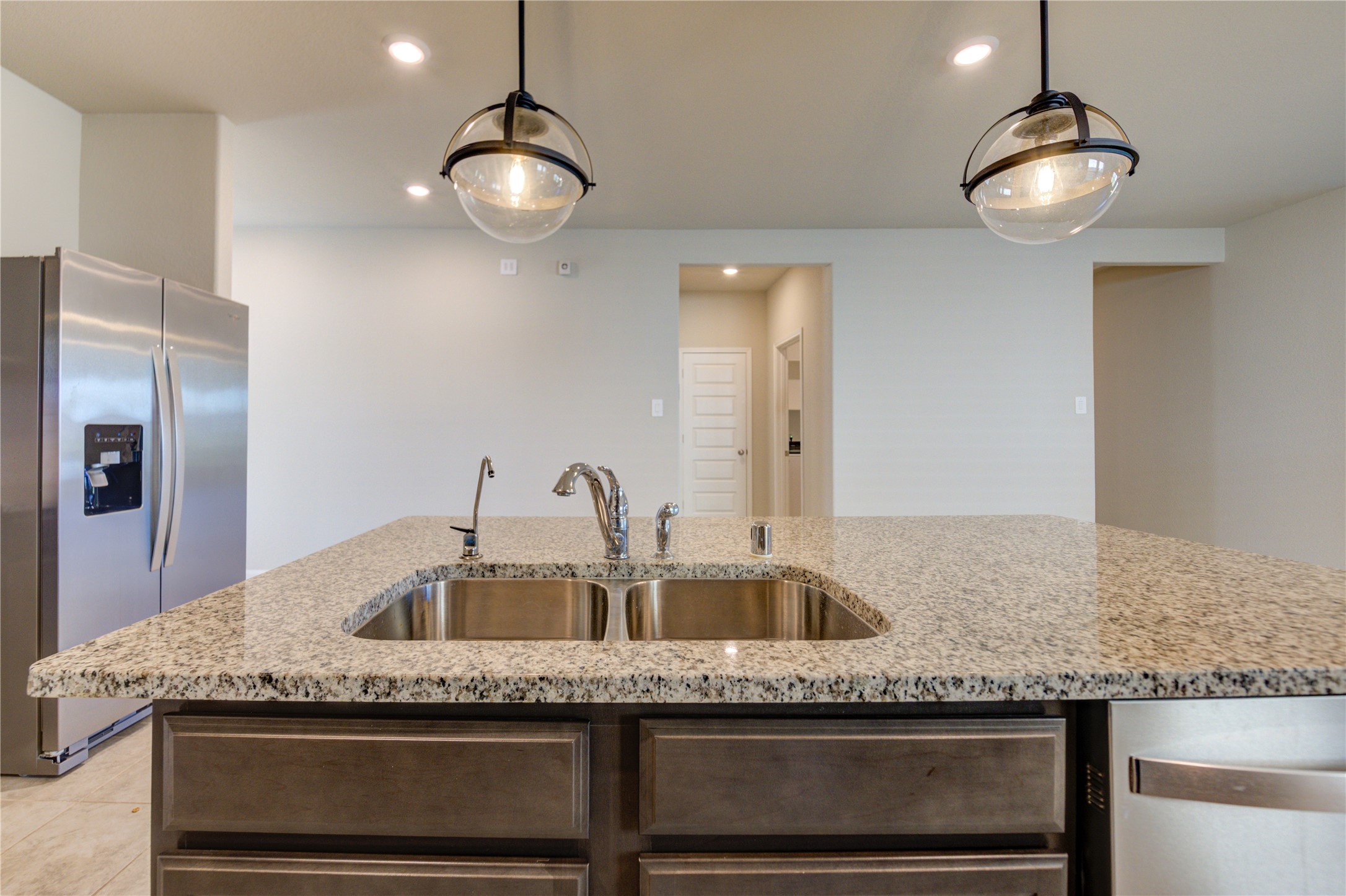 1207 Cascade Hls Drive Rosharon, TX 77583 - Photo 18 of 41 a kitchen with a granite countertop sink and refrigerator