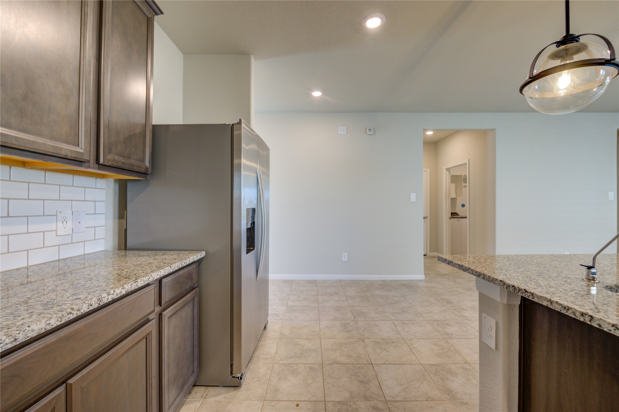 1207 Cascade Hls Drive Rosharon, TX 77583 - Photo 21 of 41 a kitchen with kitchen island granite countertop a sink and a refrigerator
