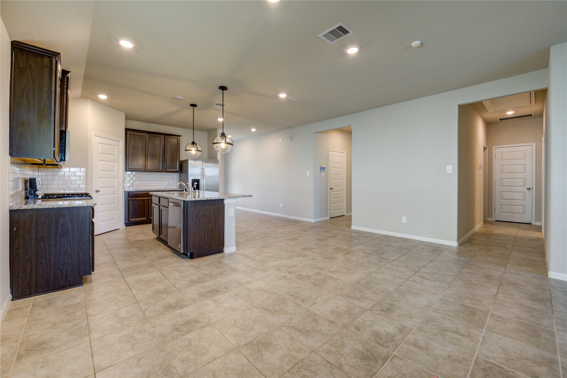 1207 Cascade Hls Drive Rosharon, TX 77583 - Photo 27 of 41 a large kitchen with kitchen island a sink stainless steel appliances and cabinets