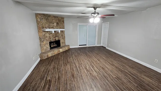 wooden floor in an empty room with a fireplace