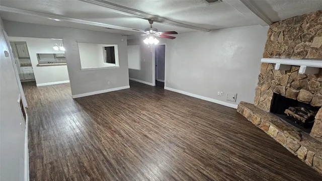 wooden floor in an empty room with a fireplace