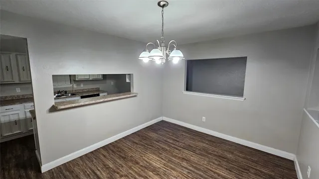 a kitchen with a refrigerator and microwave