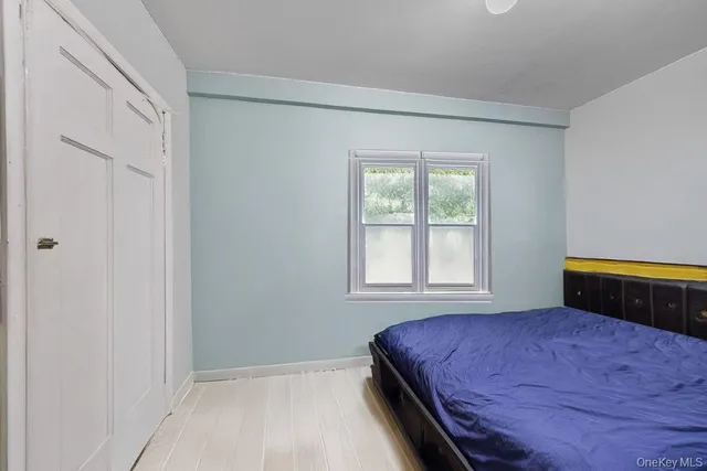 a bedroom with a bed and a window in it