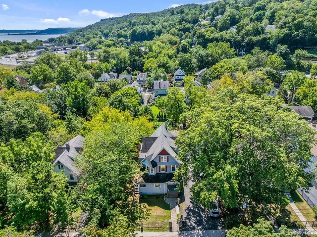 an aerial view of a house with a yard