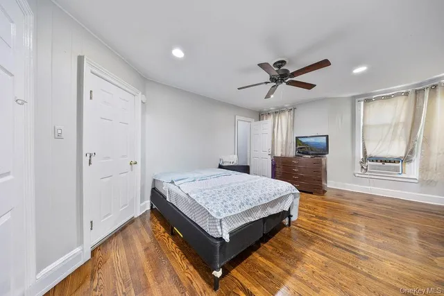 a living room with a bed and a table in it