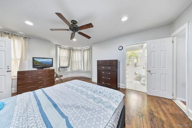 a bed room with a bed and a television