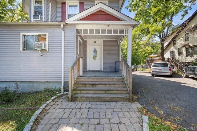 a front view of a house with a garden