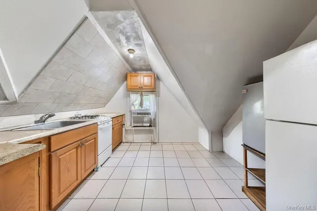 a kitchen with stainless steel appliances a stove a sink and a refrigerator