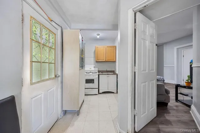 a view of a kitchen with a sink and dishwasher a refrigerator with wooden floor