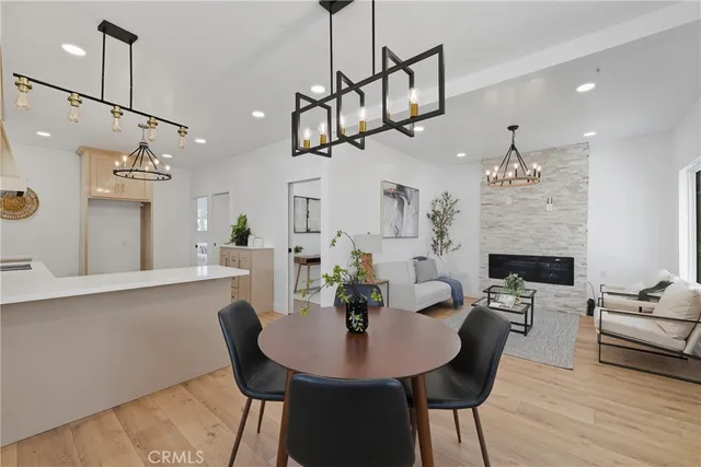 a view of a dining room with furniture wooden floor and chandelier