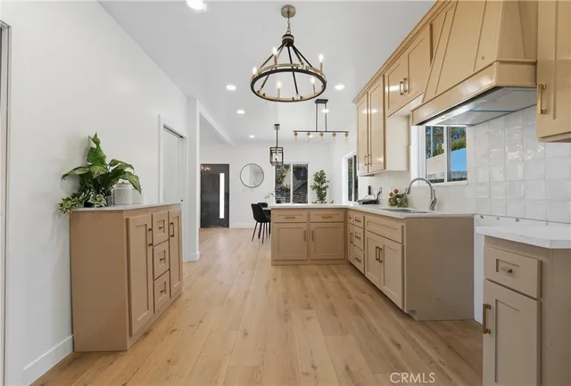 a kitchen with cabinets a sink and appliances