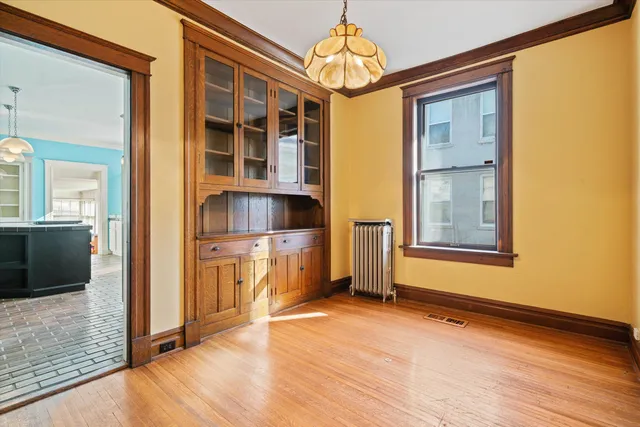a view of a room with wooden floor and cabinet