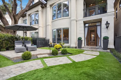 a view of a chair and table in backyard of the house