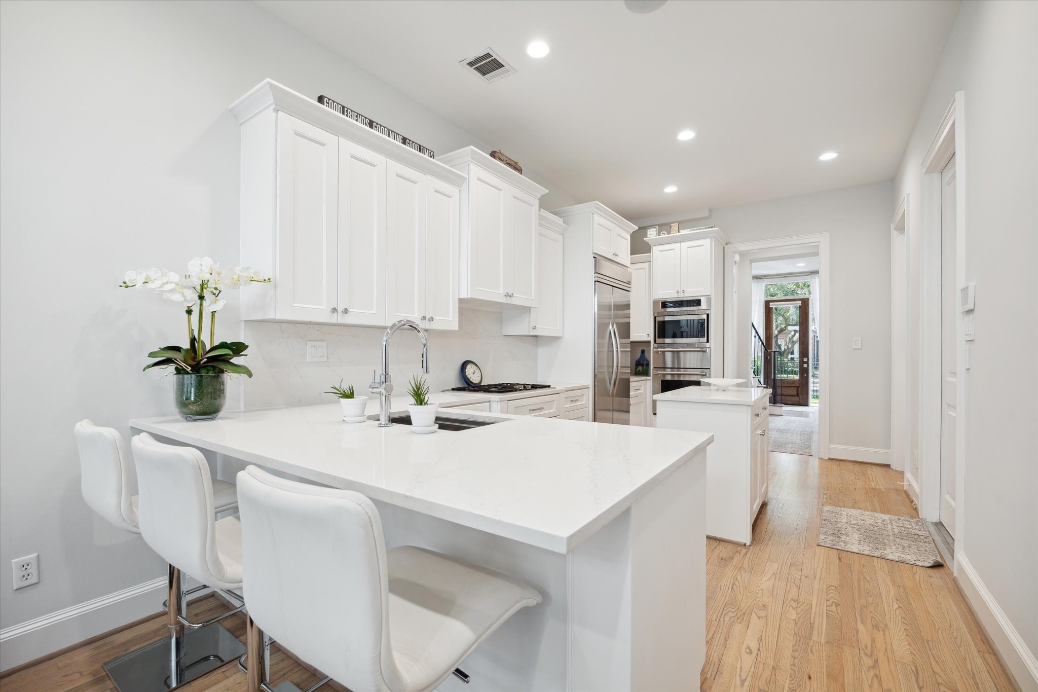2911 Mid Lane Houston, TX 77027 - Photo 14 of 31 a kitchen with kitchen island a stove a table and chairs in it