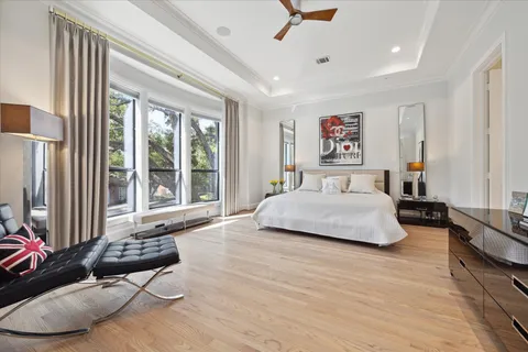 a spacious bedroom with a bed a couch and a window