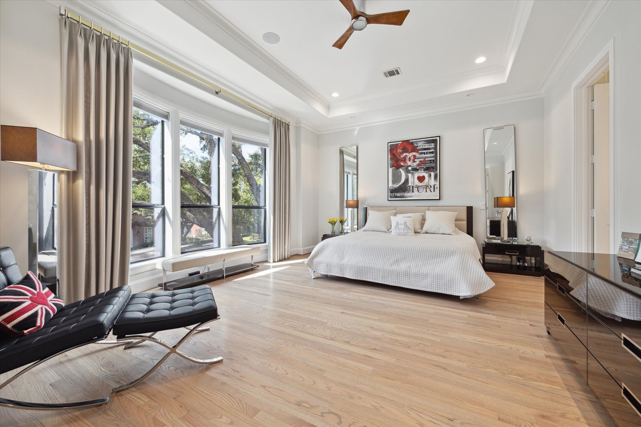 2911 Mid Lane Houston, TX 77027 - Photo 20 of 31 a spacious bedroom with a bed a couch and a window