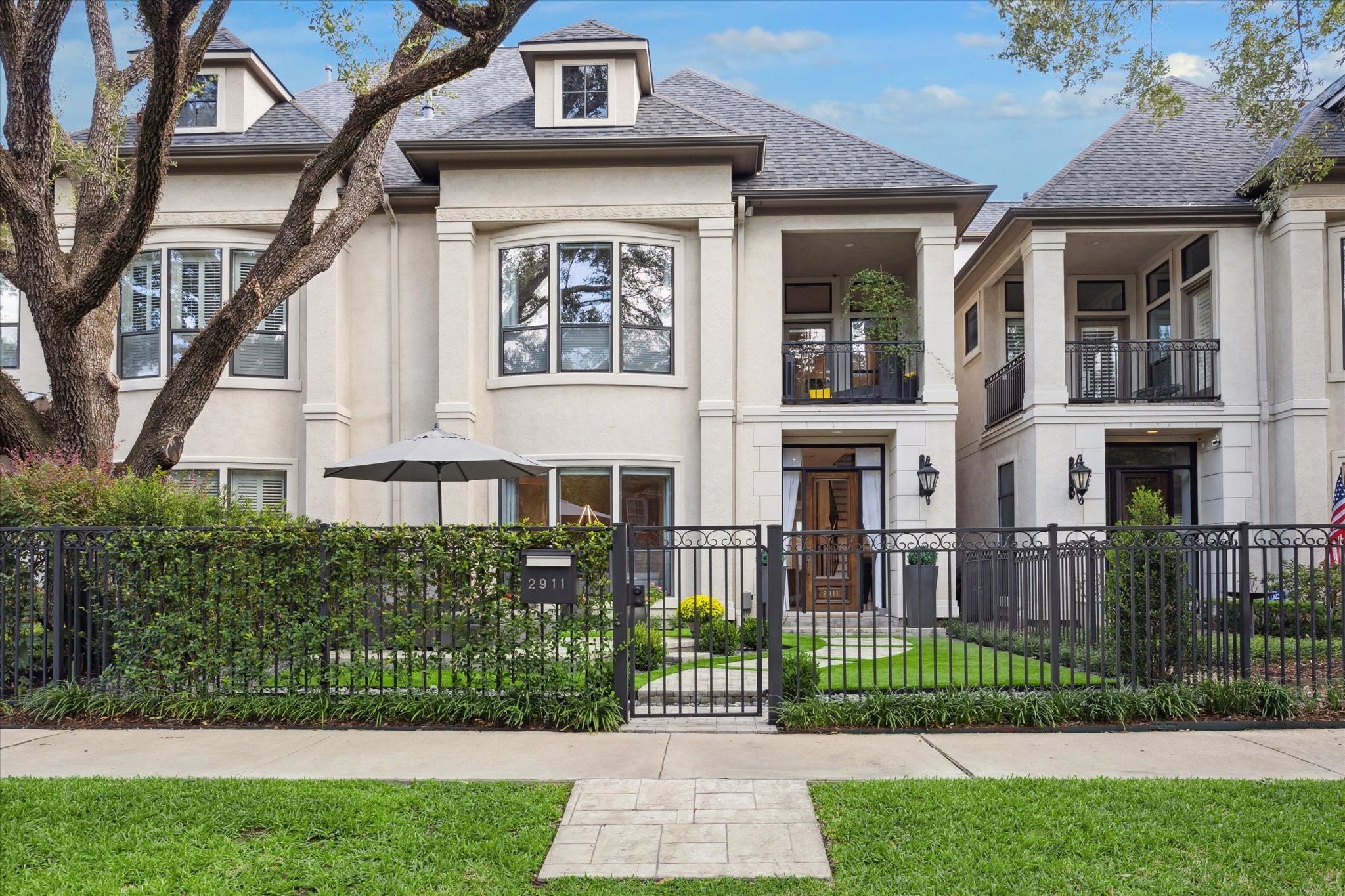 2911 Mid Lane Houston, TX 77027 - Photo 2 of 31 a front view of a house with a garden