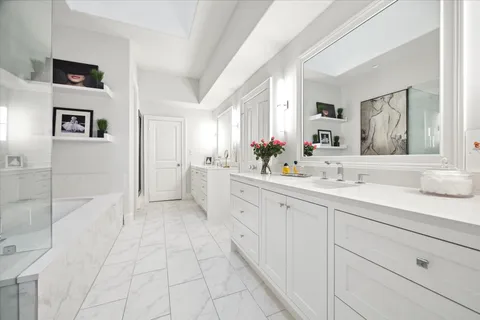a spacious bathroom with a double vanity sink mirror and