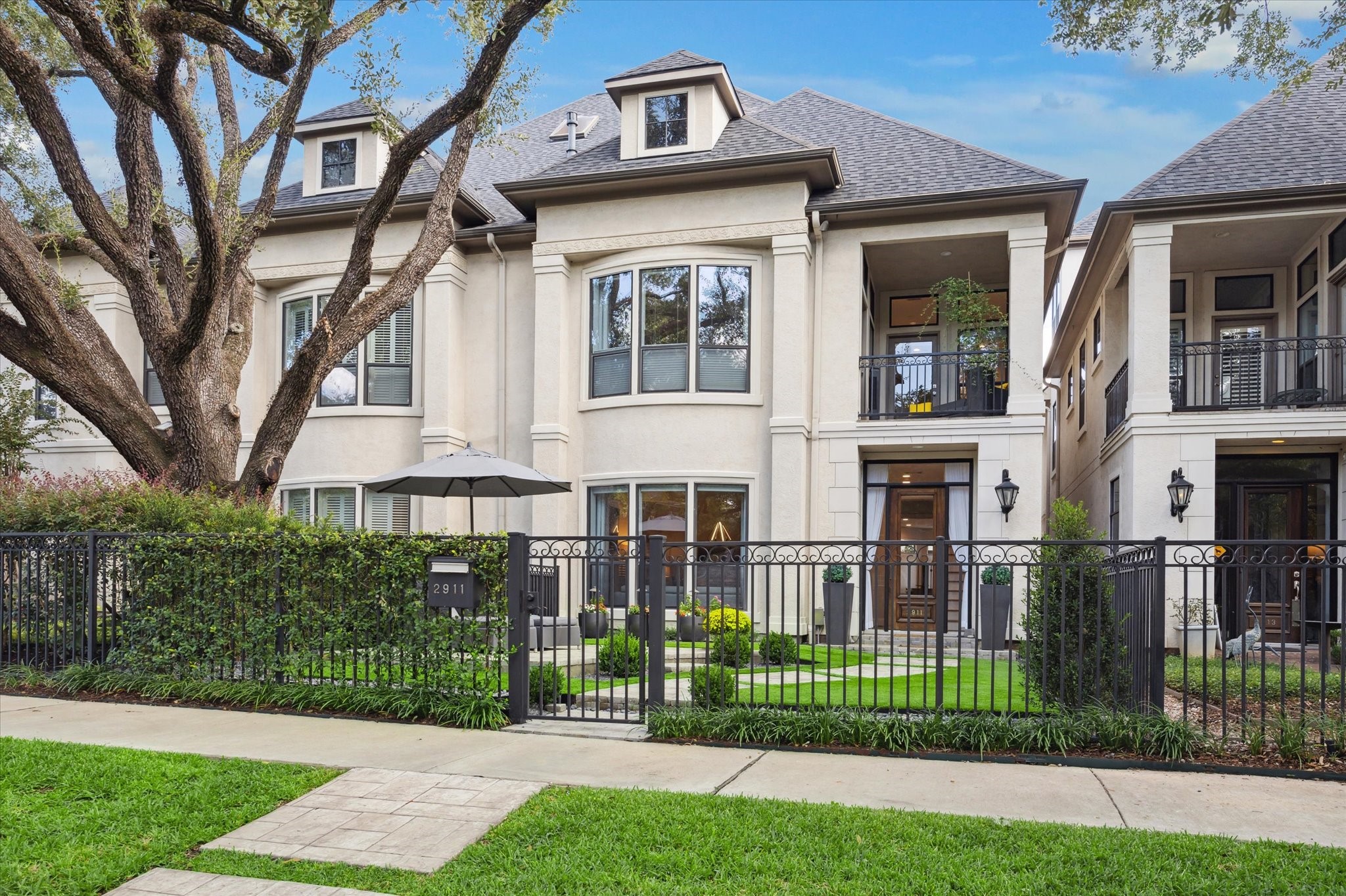 2911 Mid Lane Houston, TX 77027 - Photo 3 of 31 a view of a brick house with a yard and plants