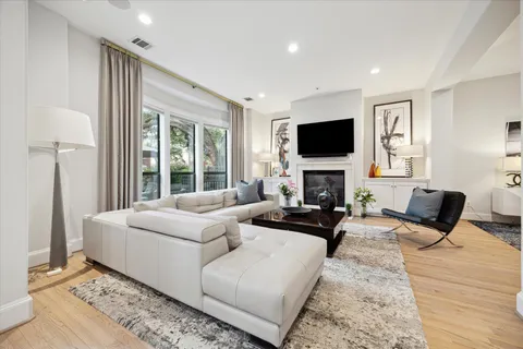 a living room with fireplace furniture and a flat screen tv