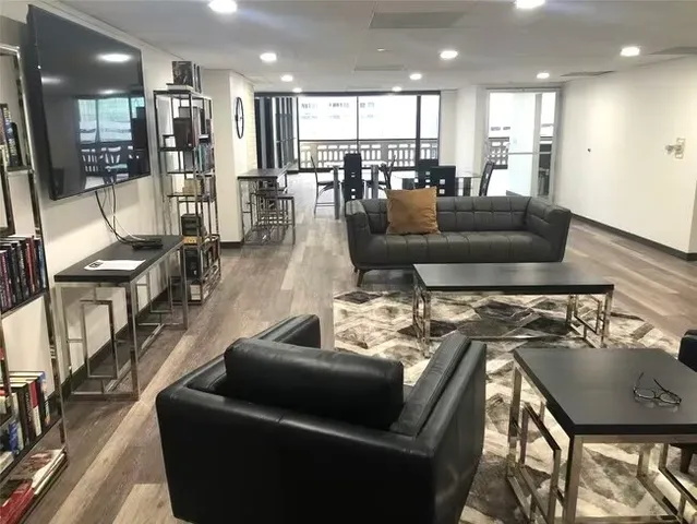 a view of a swimming pool with outdoor seating